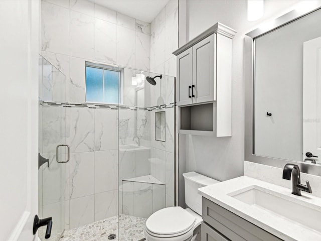 bathroom with vanity, toilet, and an enclosed shower