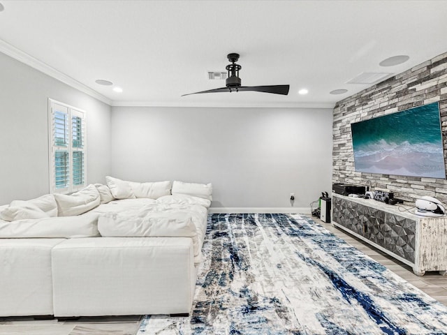 living room with light hardwood / wood-style floors, ceiling fan, and ornamental molding