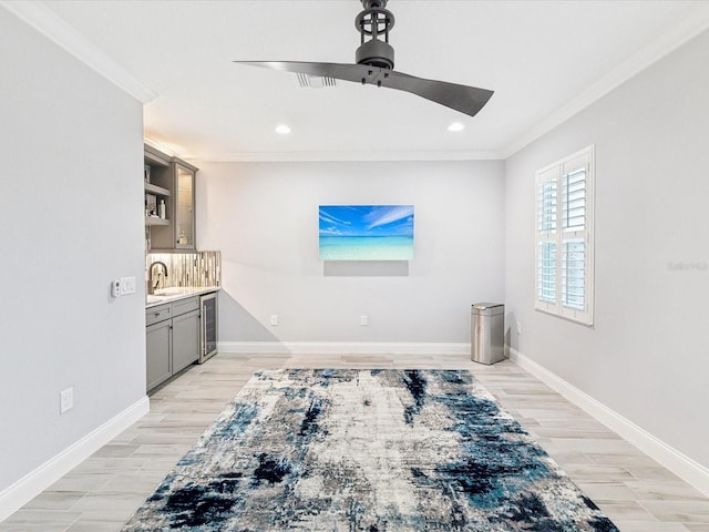 interior space with light hardwood / wood-style floors, beverage cooler, crown molding, and ceiling fan