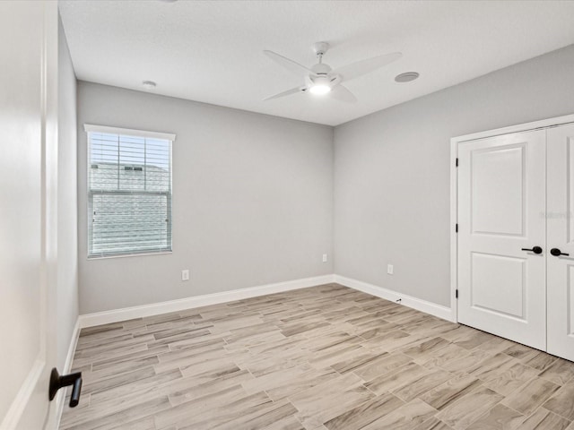 unfurnished room with ceiling fan and light hardwood / wood-style floors