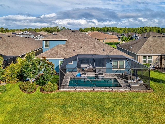 view of swimming pool featuring glass enclosure, a yard, and a patio