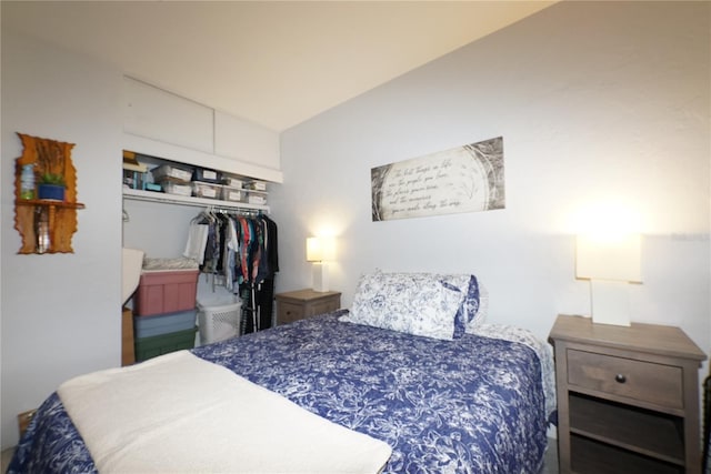 bedroom featuring vaulted ceiling and a closet