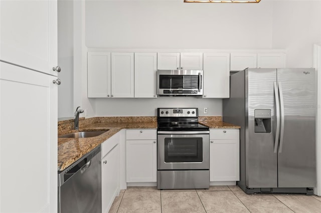 kitchen with white cabinetry, sink, dark stone counters, and appliances with stainless steel finishes