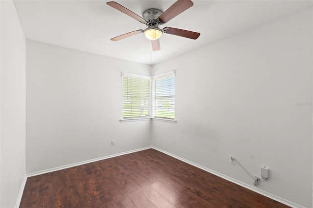 empty room with ceiling fan and dark wood-type flooring