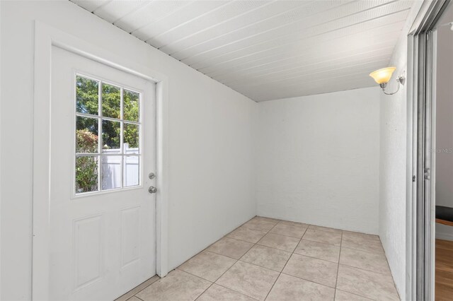 doorway to outside featuring light tile patterned flooring