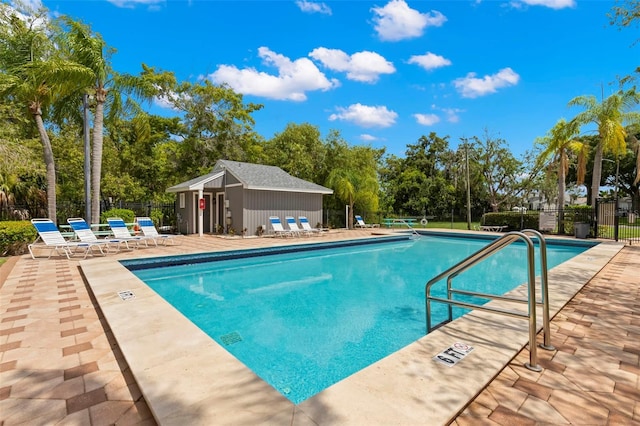 view of pool featuring a patio area and an outbuilding