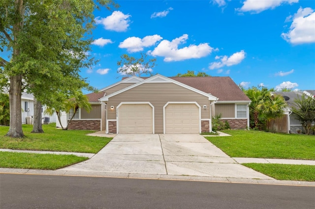 single story home featuring a front lawn and a garage