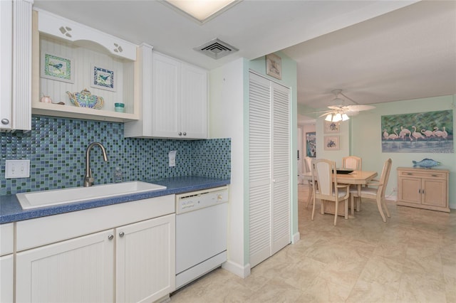 kitchen with sink, dishwasher, ceiling fan, backsplash, and white cabinets