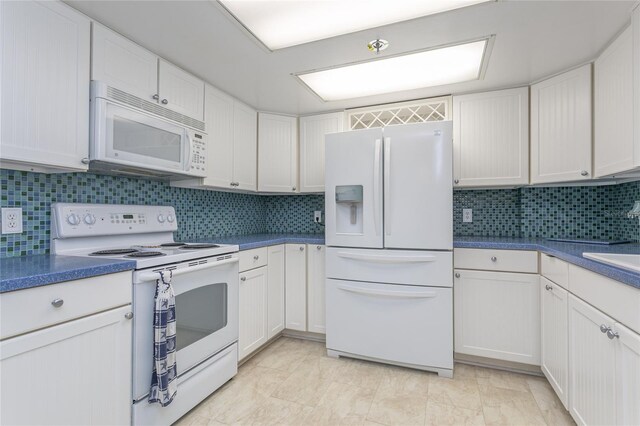 kitchen featuring tasteful backsplash, white cabinetry, and white appliances