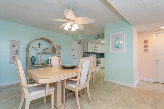 dining area featuring a textured ceiling and ceiling fan