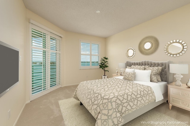 carpeted bedroom featuring a textured ceiling