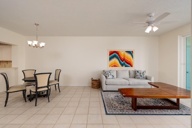 living room with a textured ceiling, ceiling fan with notable chandelier, and light tile patterned floors