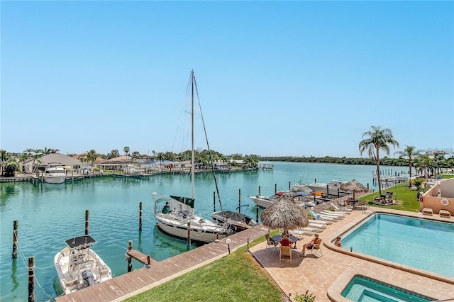 dock area with a water view and a community pool