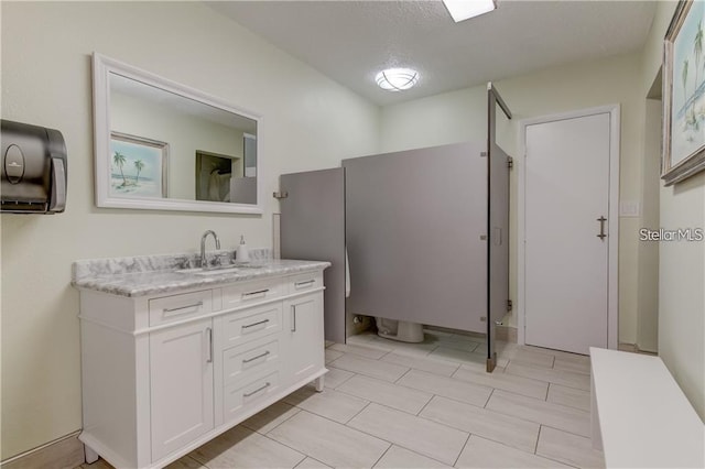 bathroom with vanity and a textured ceiling