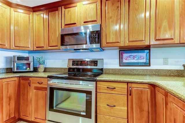 kitchen with light stone counters and stainless steel appliances