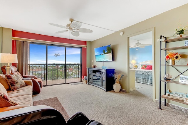 carpeted living room with ceiling fan