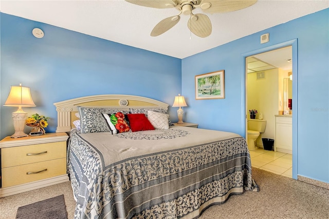 carpeted bedroom featuring ceiling fan and ensuite bath