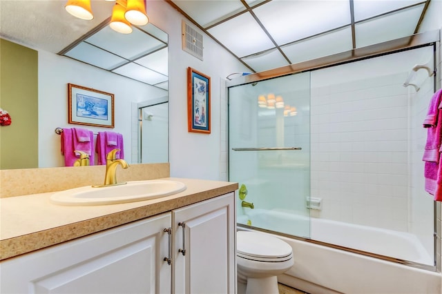 full bathroom featuring shower / bath combination with glass door, vanity, and toilet