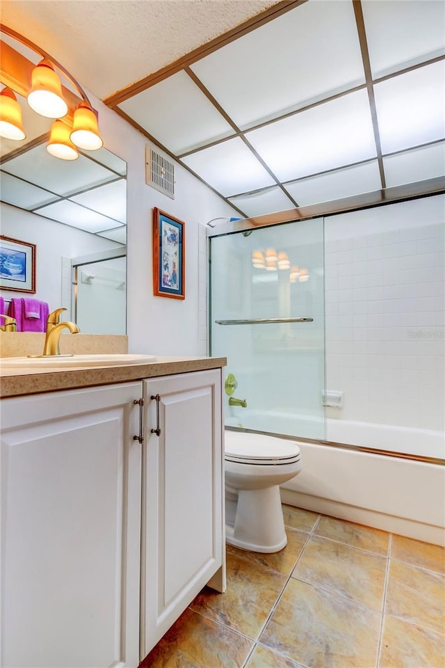 full bathroom with vanity, toilet, and combined bath / shower with glass door