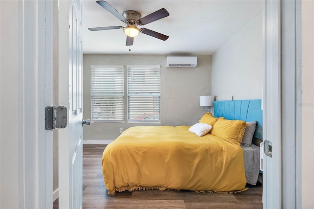 bedroom featuring ceiling fan, dark hardwood / wood-style floors, and a wall unit AC