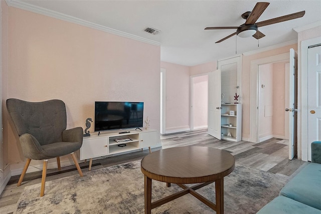 living room with ceiling fan, hardwood / wood-style floors, and ornamental molding