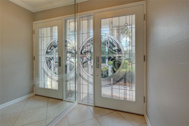 tiled foyer featuring crown molding and baseboards