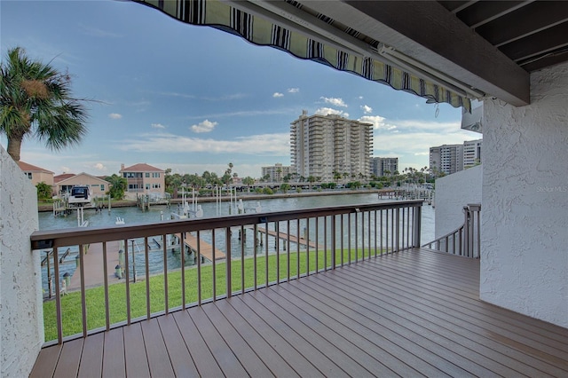 deck with a yard and a water view