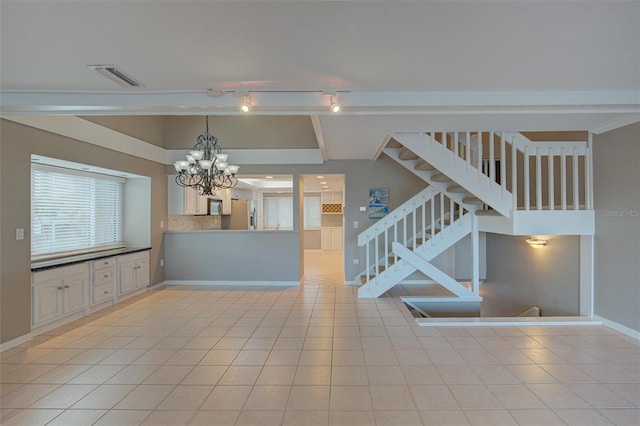 interior space with light tile patterned floors, stairway, visible vents, and an inviting chandelier