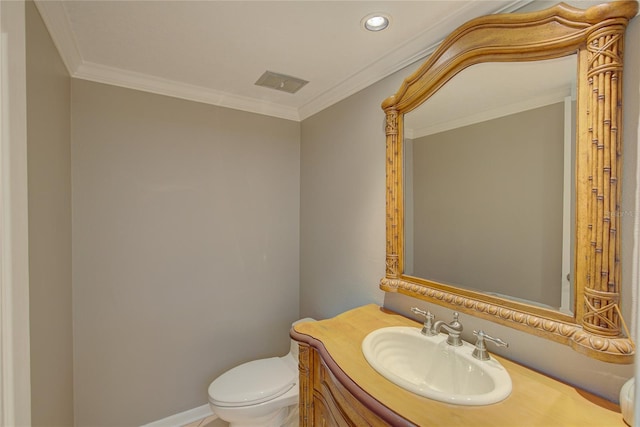 bathroom featuring toilet, crown molding, and vanity