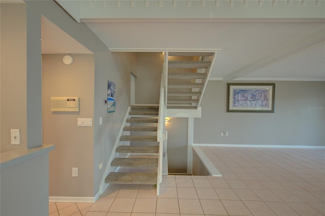 stairs with tile patterned floors and crown molding