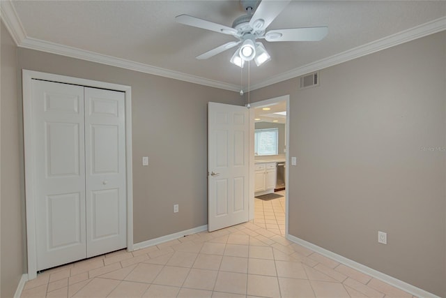 unfurnished bedroom featuring light tile patterned floors, ceiling fan, ornamental molding, and a closet