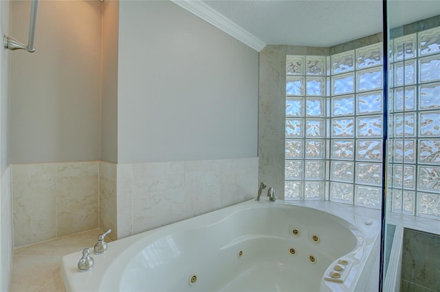 bathroom featuring crown molding, a textured ceiling, and tiled tub