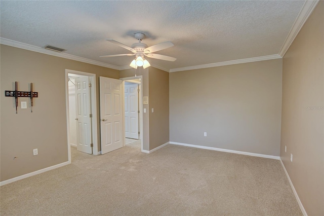 unfurnished bedroom with ceiling fan, ornamental molding, and light colored carpet