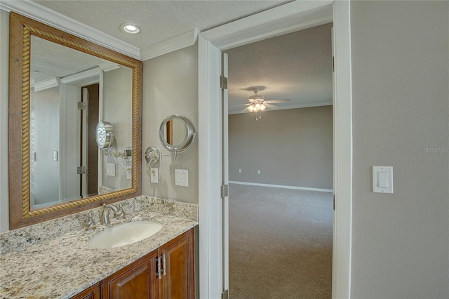 bathroom with ceiling fan, a textured ceiling, vanity, and crown molding