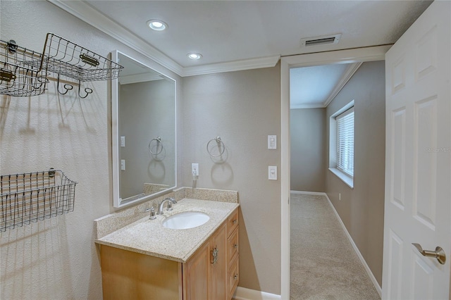 bathroom featuring visible vents, recessed lighting, crown molding, baseboards, and vanity