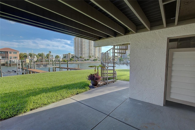 view of patio with a boat dock and a water view