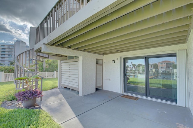 view of patio / terrace with stairs and fence