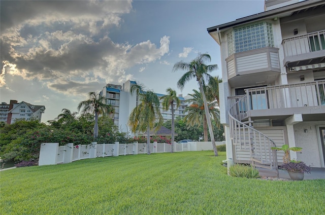 view of yard featuring stairway and fence