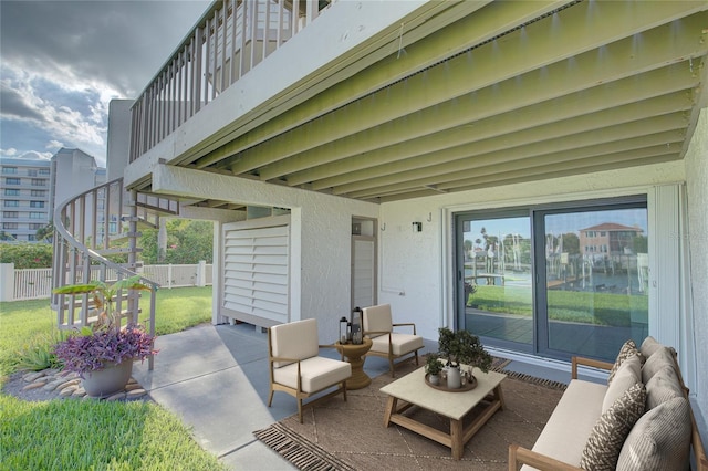 view of patio with outdoor lounge area, stairs, and fence