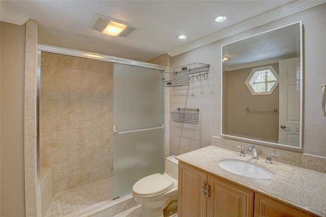 bathroom featuring vanity, visible vents, a stall shower, ornamental molding, and toilet