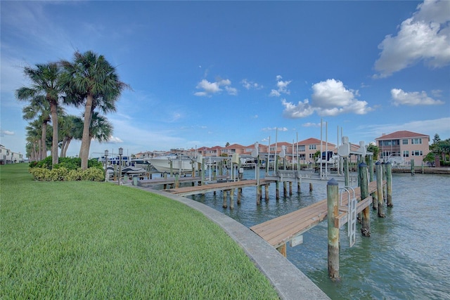 dock area featuring a yard, a water view, a residential view, and boat lift