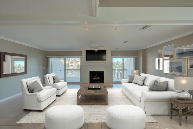 living area with visible vents, a large fireplace, a healthy amount of sunlight, and crown molding