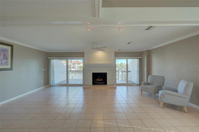 unfurnished living room with visible vents, a large fireplace, crown molding, baseboards, and light tile patterned floors