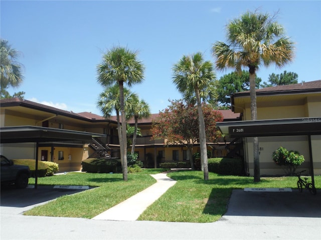 view of community with a carport and a yard