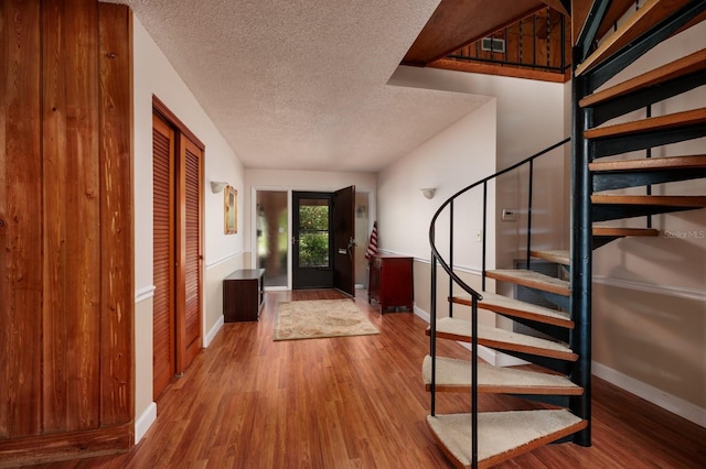 entrance foyer featuring wood-type flooring and a textured ceiling