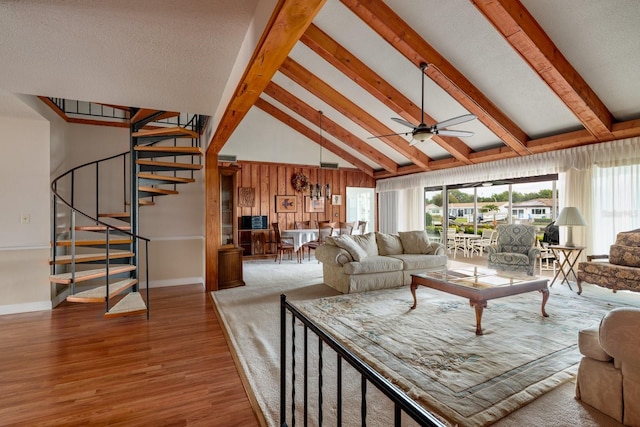 living room with hardwood / wood-style floors, high vaulted ceiling, ceiling fan, and beam ceiling