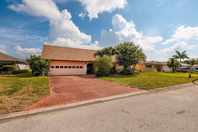 ranch-style house featuring a front yard and a garage