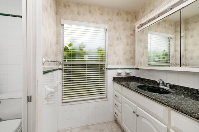 bathroom featuring tile patterned flooring, vanity, and toilet