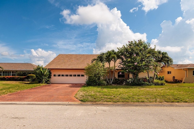 view of front of home featuring a garage and a front lawn