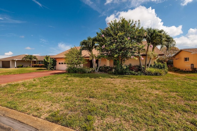 view of front of home featuring a garage and a front yard